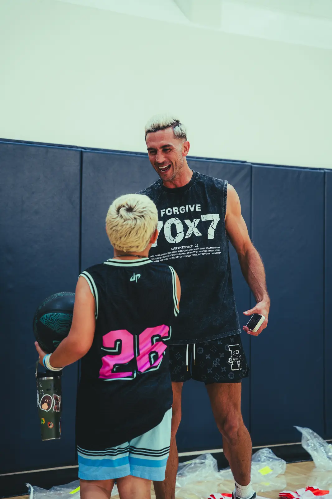 Jordan Lawley laughing with a young player at Boombase