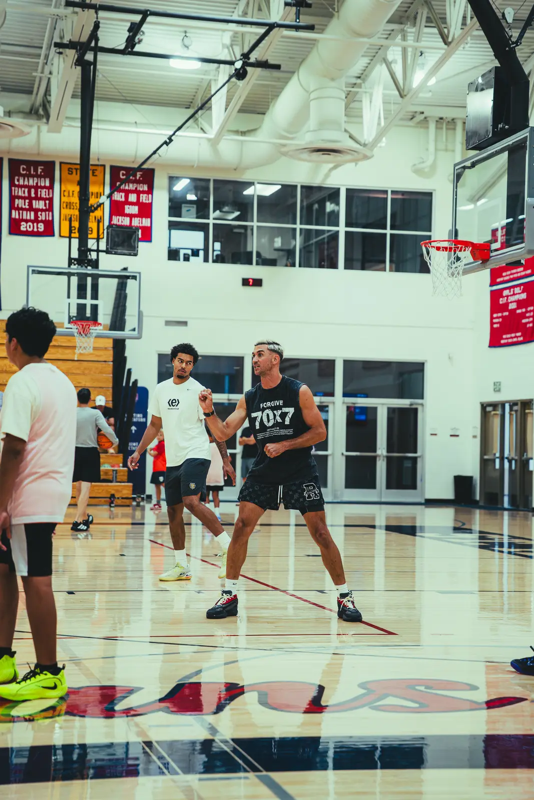 Jordan Lawley coaching players through a drill in the gym