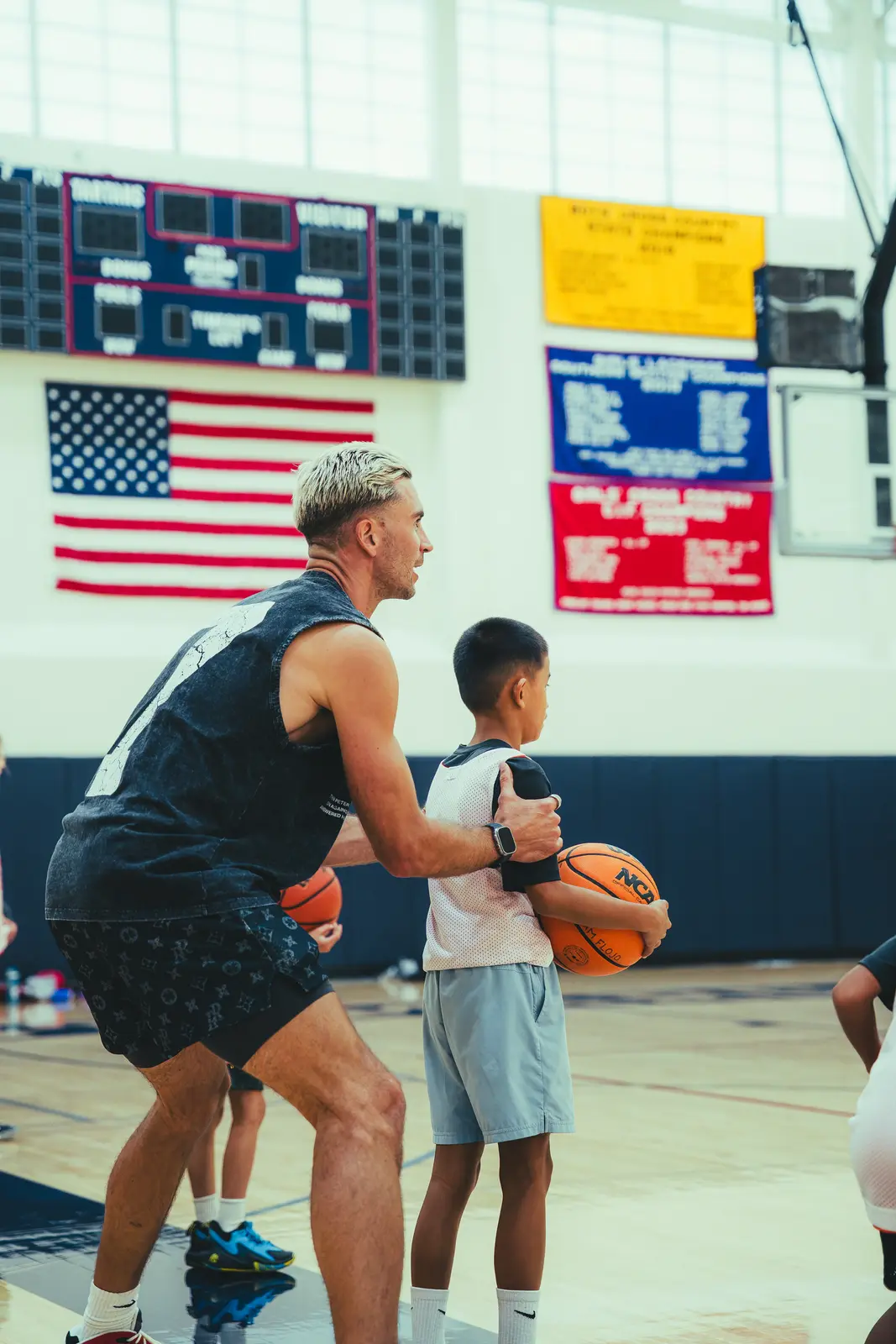 Jordan Lawley coaching a young player through his shot