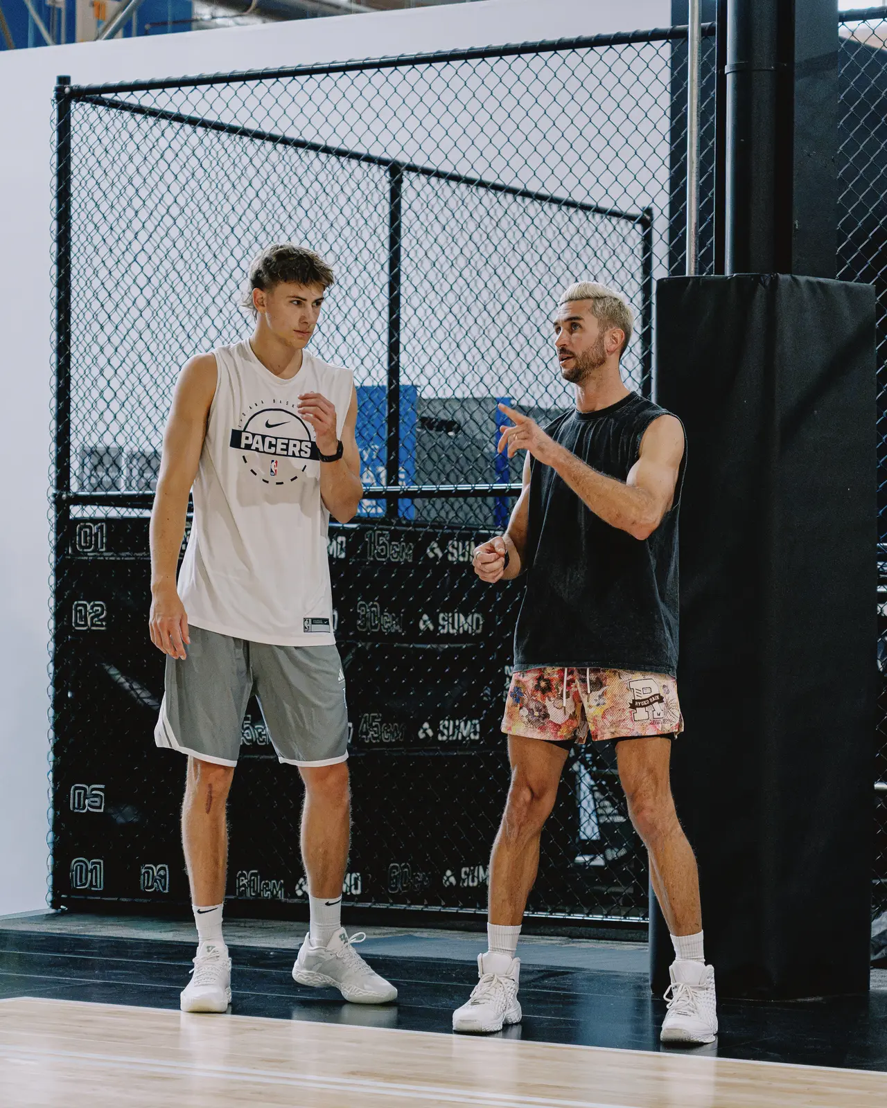 Jordan Lawley teaching a player on the court