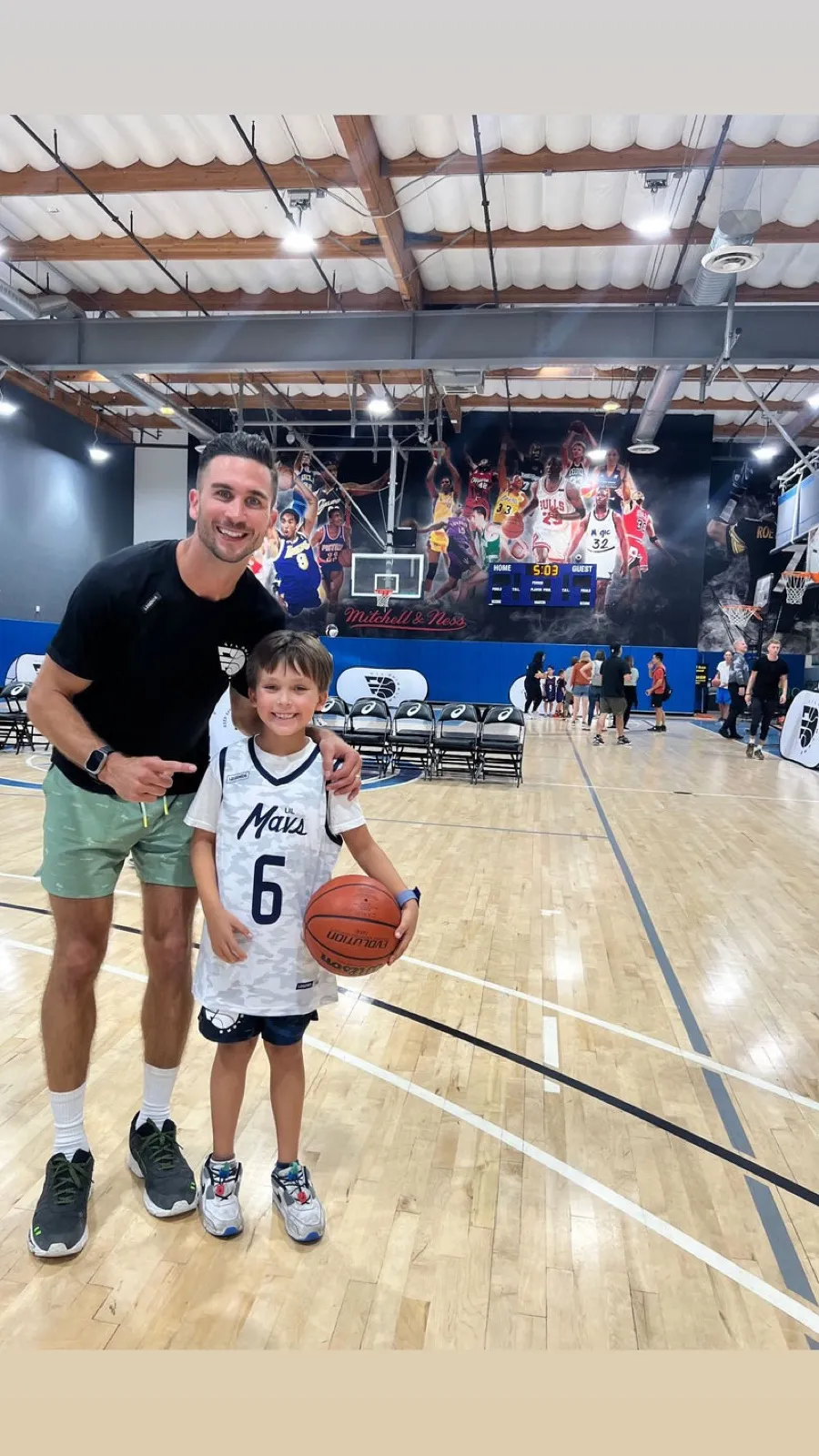 Jordan Lawley with a young player at the gym